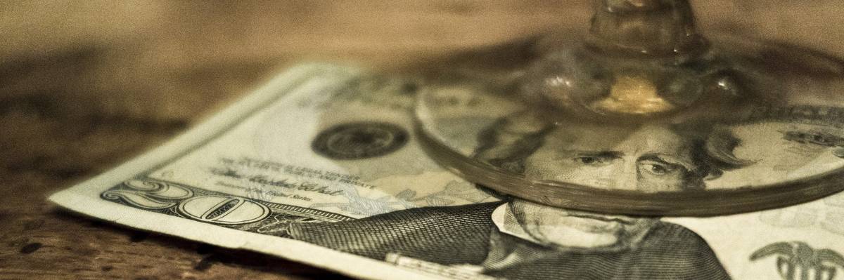 20 Dollar bill under a glass