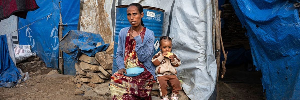 35-year-old Letebrahan sits outside the tent she shares with her one-year-old daughter, Zenehawit