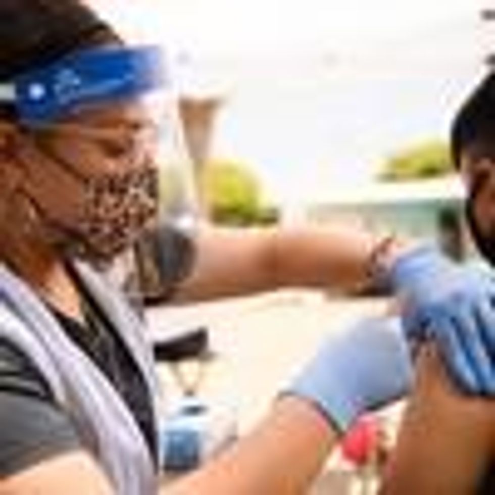A 17-year-old receives a first dose of the Pfizer Covid-19 vaccine at a mobile clinic during a back to school event offering school supplies, face masks, vaccinations, and other resources for children and their families at the Weingart East Los Angeles YMCA on August 7, 2021. (Photo: Patrick T. Fallon/AFP via Getty Images)