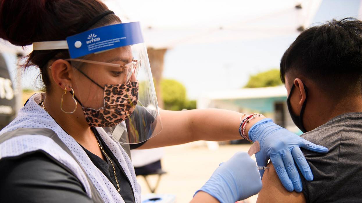 A 17-year-old receives a first dose of the Pfizer Covid-19 vaccine at a mobile clinic during a back to school event offering school supplies, face masks, vaccinations, and other resources for children and their families at the Weingart East Los Angeles YMCA on August 7, 2021. (Photo: Patrick T. Fallon/AFP via Getty Images)