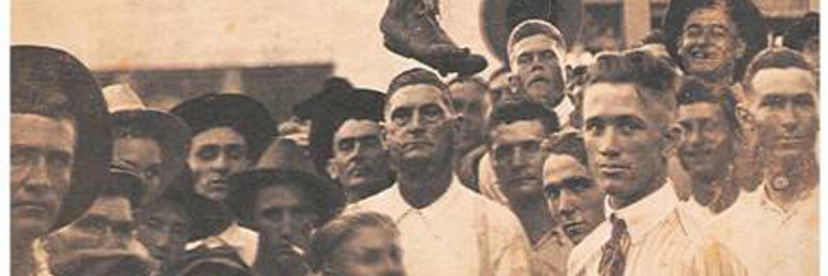 A 19th century crowd contentedly watches and celebrates the lynching of a black man in the American South. the