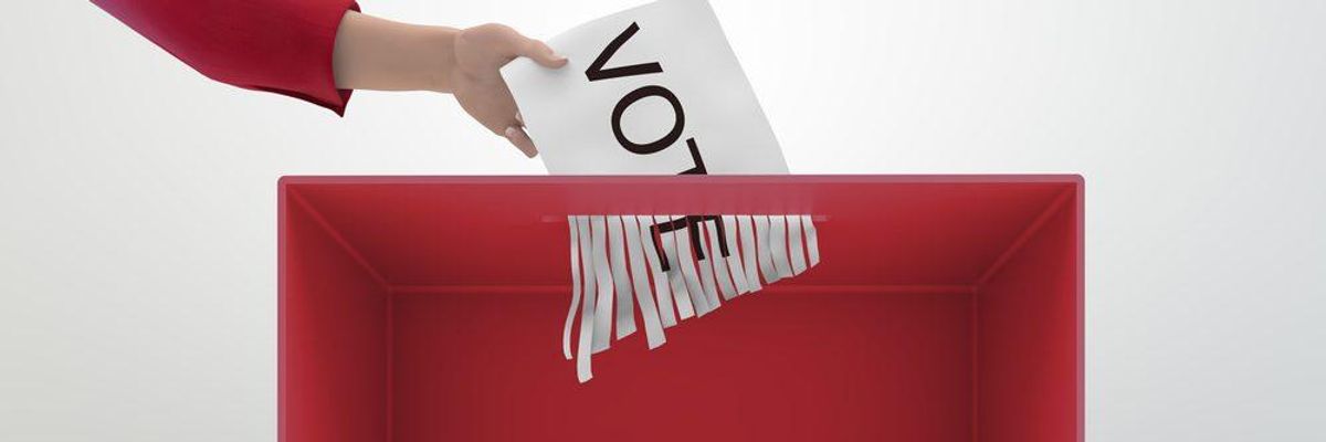 A ballot is shredded as a voter puts it in a voting box.