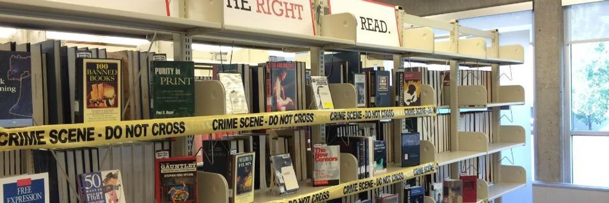 A Banned Books Week display with books under yellow crime scene tape. 