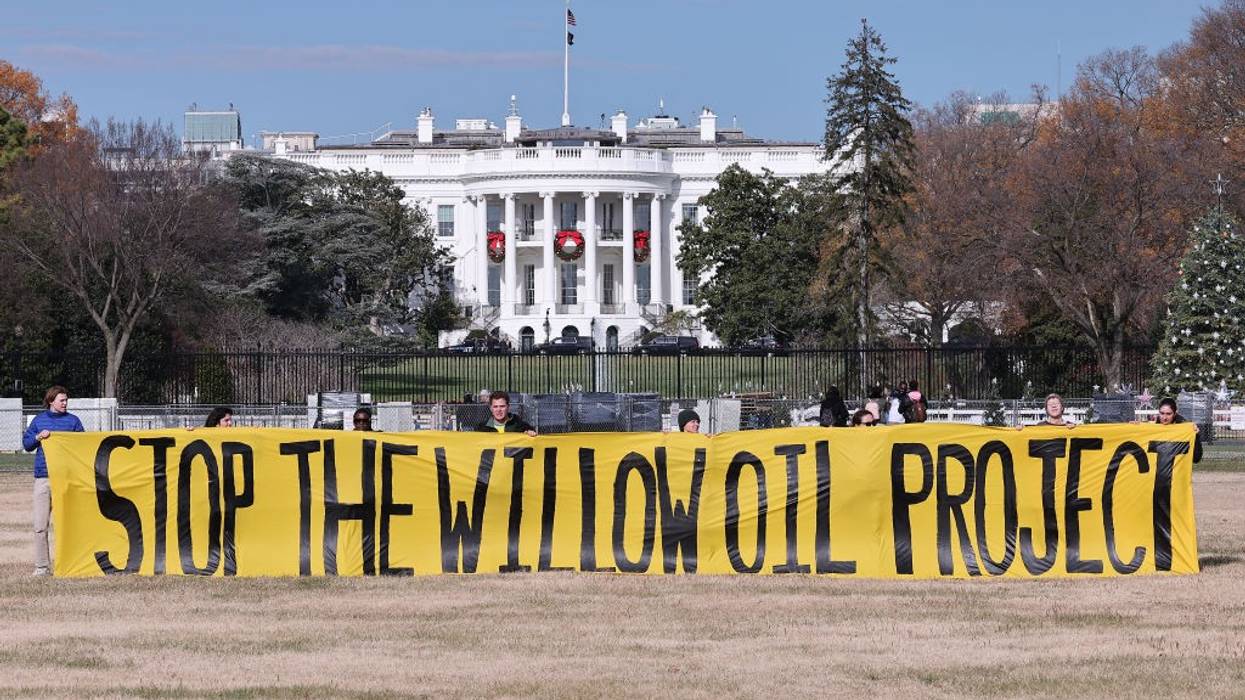 A banner outside the White House reads, "Stop the Willow oil project."