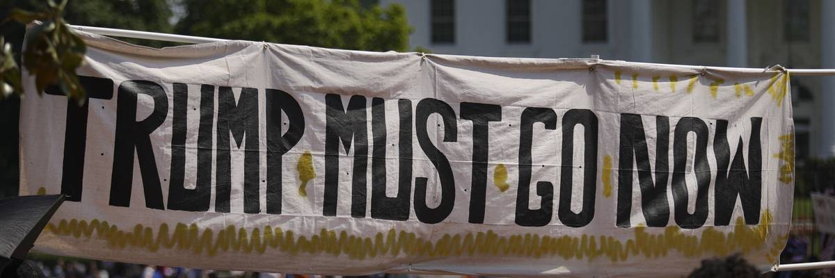 A banner reads 'Trump must go now.'