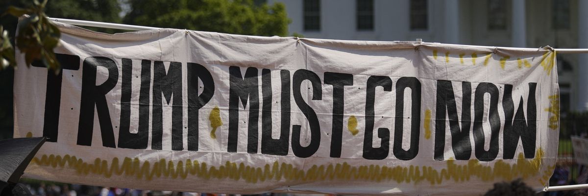 A banner reads 'Trump must go now.'