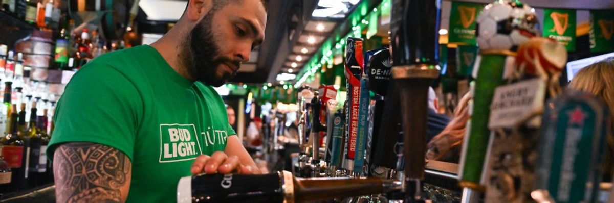 A bartender pours a beer