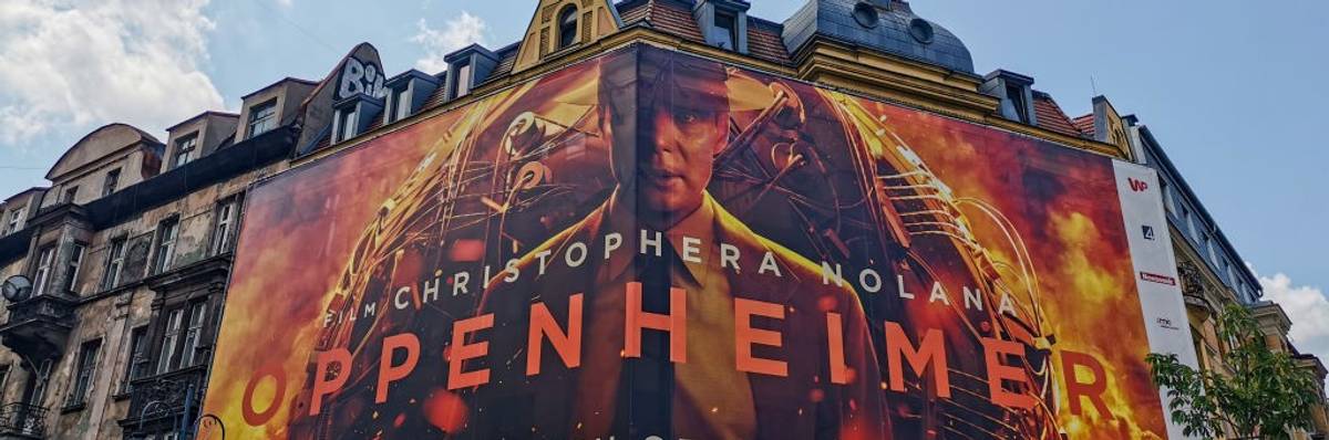 A billboard for the movie Oppenheimer on top of an old building.