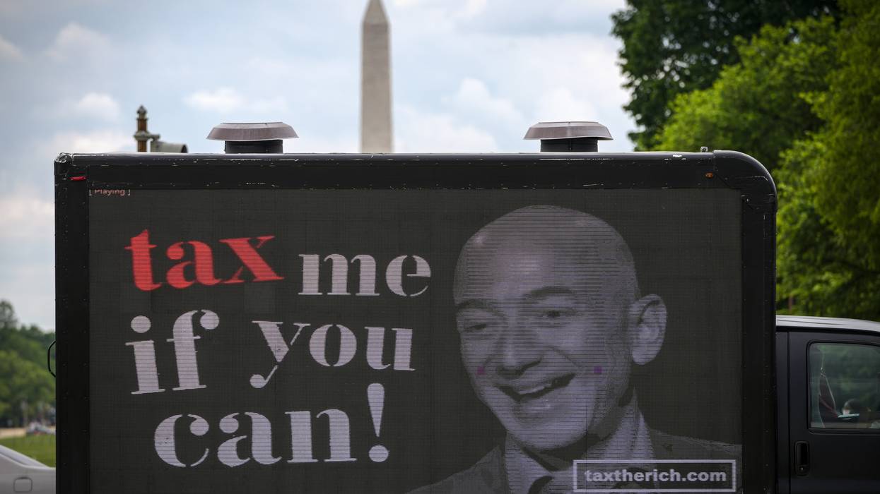 A billboard of Jeff Bezos reading, "Tax me if you can!"