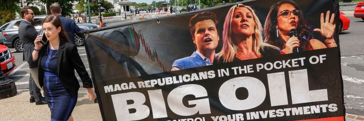 A billboard on wheels reading, "MAGA Republicans in the Pocket of Big Oil."