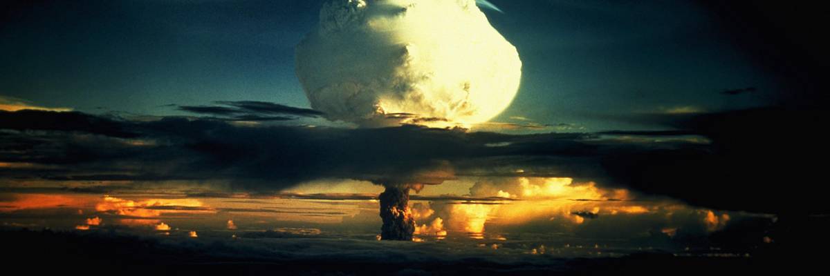 A billowing white mushroom cloud, mottled with orange, pushes through a layer of clouds during Operation Ivy, the first test of a hydrogen bomb, at Enewetak Atoll in the Marshall Islands. (Photo by © CORBIS/Corbis via Getty Images)