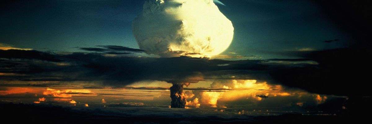A billowing white mushroom cloud, mottled with orange, pushes through a layer of clouds during Operation Ivy, the first test of a hydrogen bomb, at Enewetak Atoll in the Marshall Islands. (Photo by © CORBIS/Corbis via Getty Images)