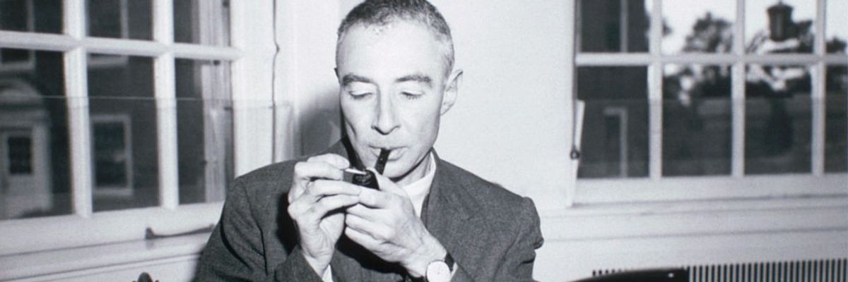 A black-and-white photo of J. Robert Oppenheimer smoking a pipe.