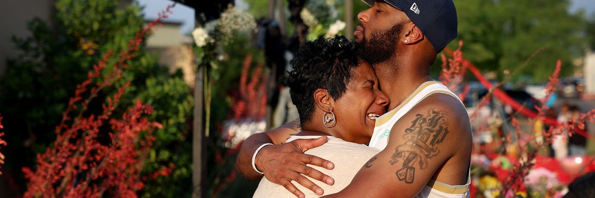 A black mother and son hugs after another senseless mass shooting in Texas.
