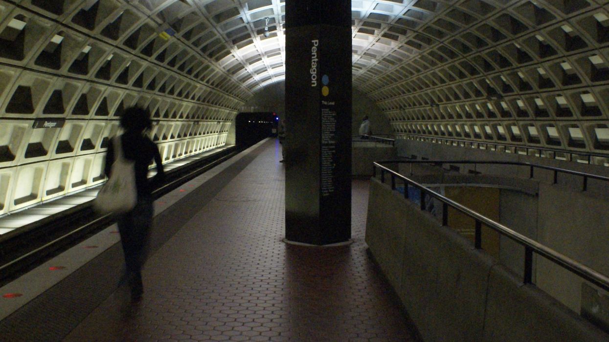 A blurred commuter walks through the D.C. Metro Pentagon station.