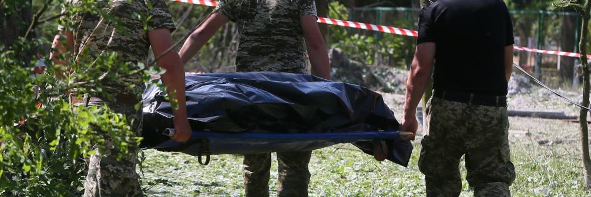 A body carried away from a bomb site.