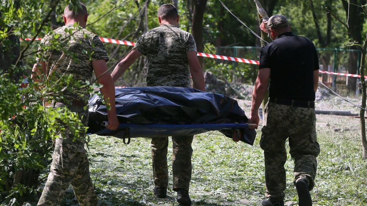 A body carried away from a bomb site.