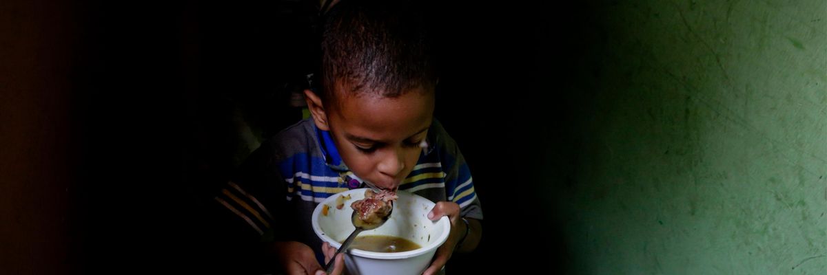 A boy eats soup prepared and donated by a local restaurant on April 12, 2019 in Caracas, Venezuela. (Photo: Eva Marie Uzcategui via Getty Images)
