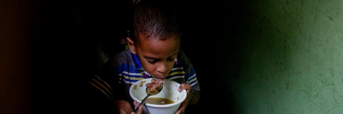 A boy eats soup prepared and donated by a local restaurant on April 12, 2019 in Caracas, Venezuela. (Photo: Eva Marie Uzcategui via Getty Images)