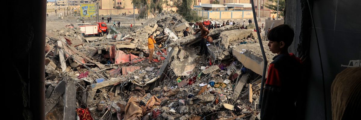 A boy examines the rubble of a building in Gaza