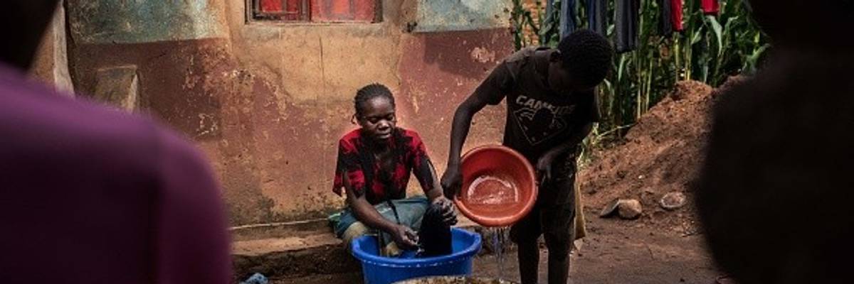 A boy fetches water from his family's well