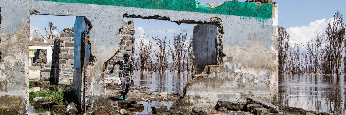 A boy walks past a flood-damaged building near Nakuru, Kenya on September 17, 2022.