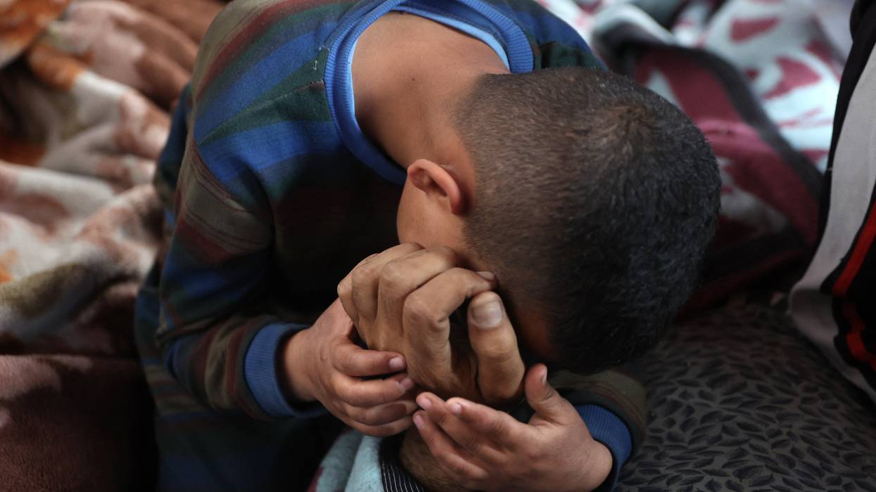 A boys mourns over the body of a loved one killed in an Israeli attack on northern Gaza