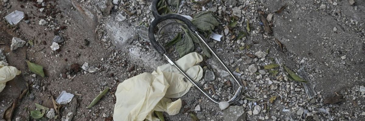 a broken stethoscope and surgical glove are seen on the ground after an Israeli bombing in Lebanon