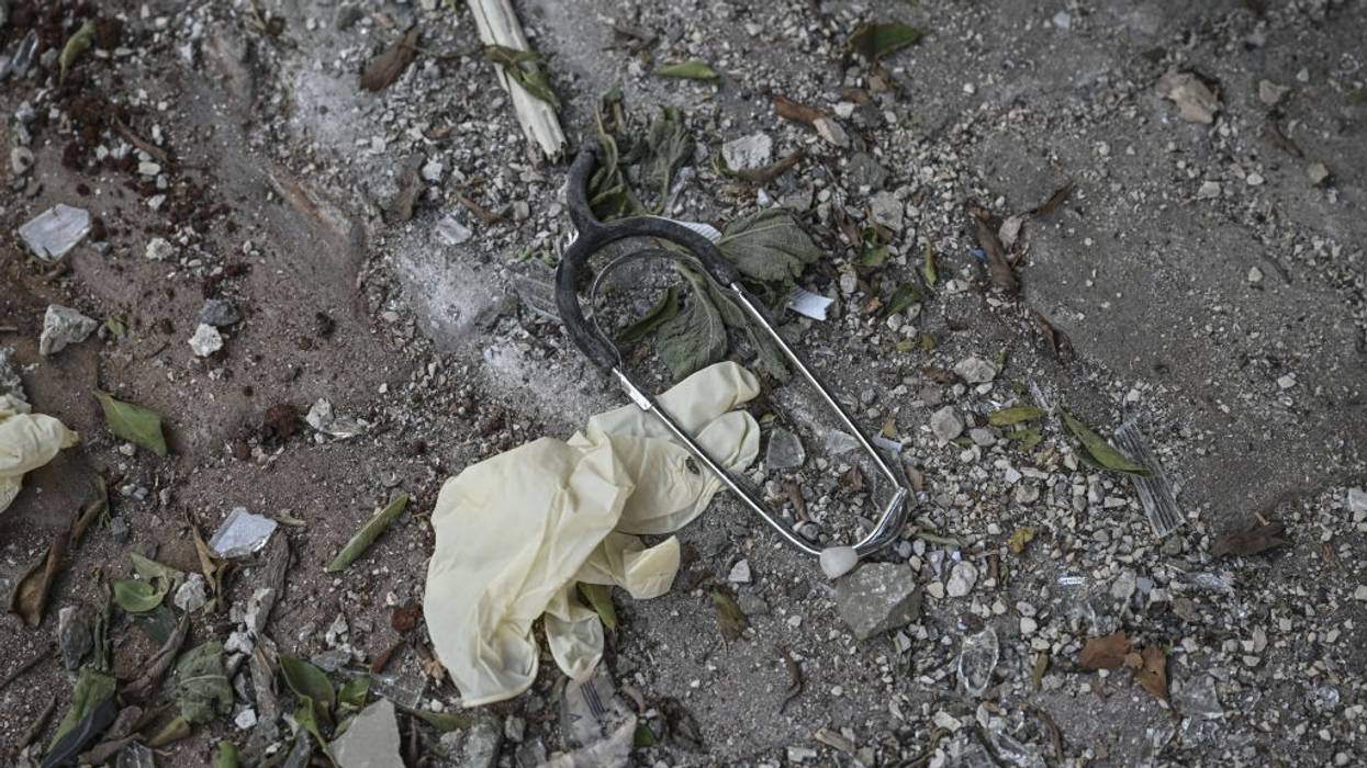 a broken stethoscope and surgical glove are seen on the ground after an Israeli bombing in Lebanon