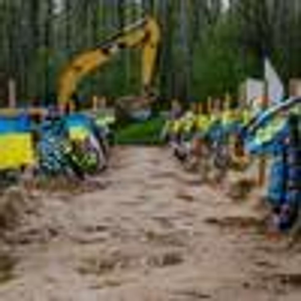 A bulldozer digs graves in Ukraine