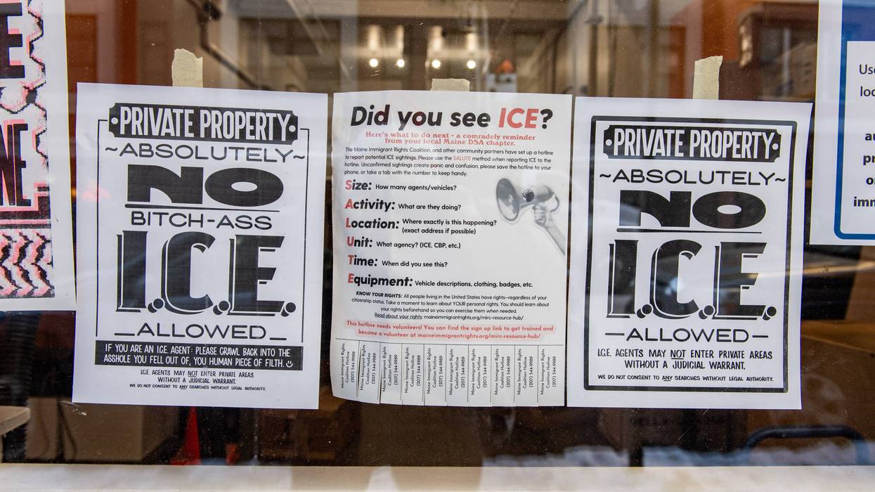 A business is seen with signs in its windows protesting US Immigration and Customs Enforcement
