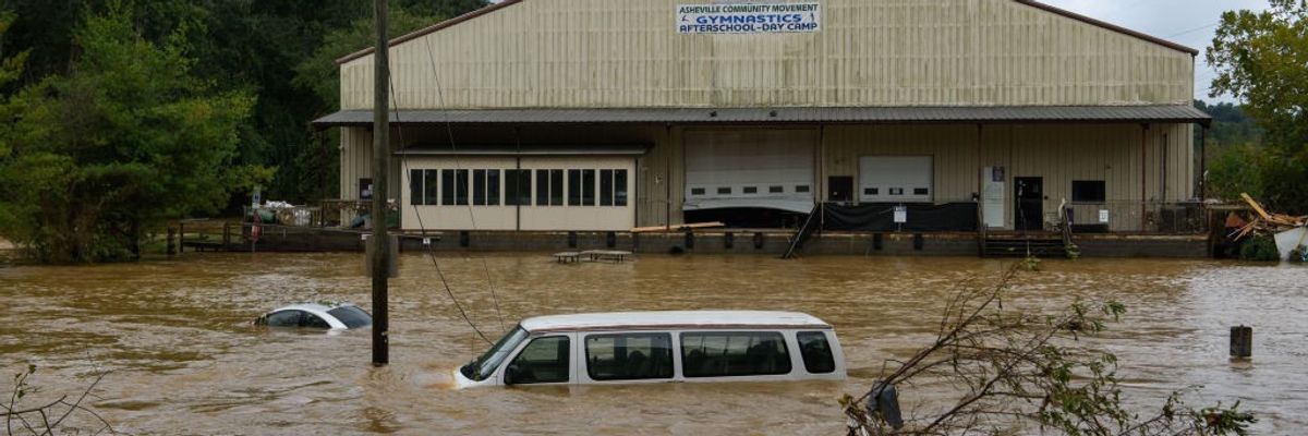 A car and van submerged in Asheville, North Carolina following Hurricane Helene