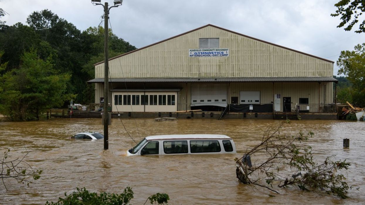 A car and van submerged in Asheville, North Carolina following Hurricane Helene