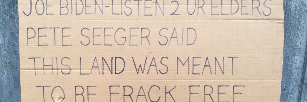 A cardboard protest sign. 