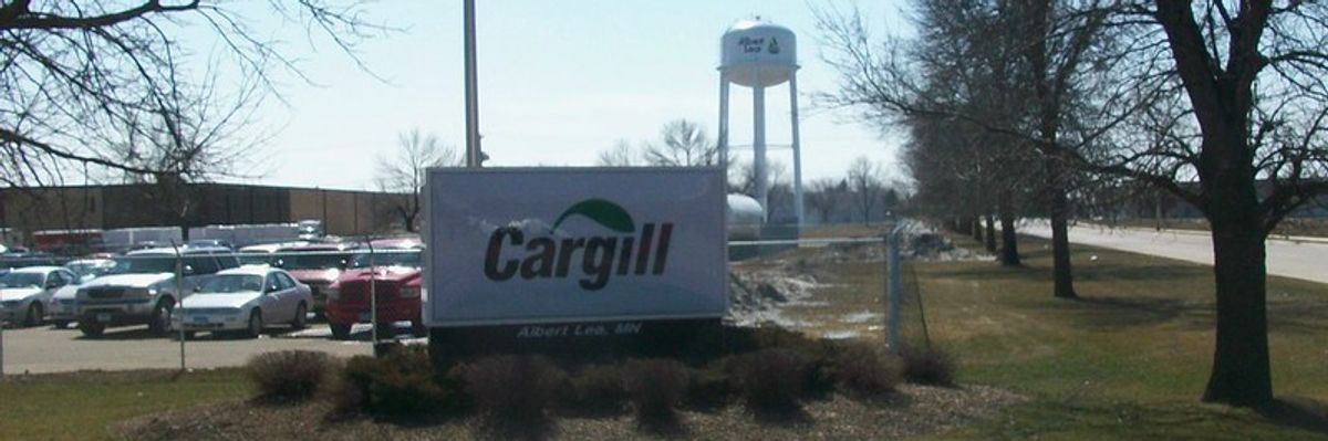 A Cargill billboard is shown in front of a parking lot. 