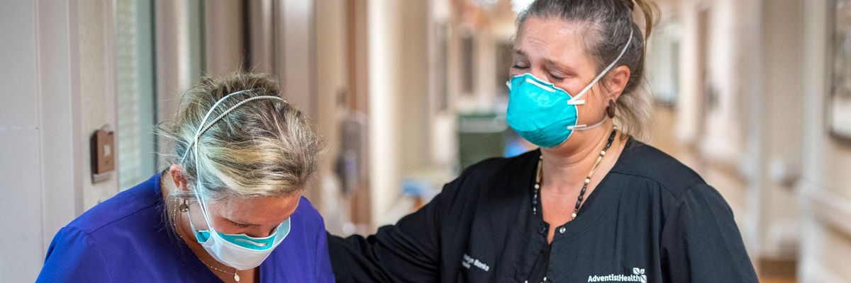 A chaplain comforts a healthcare worker