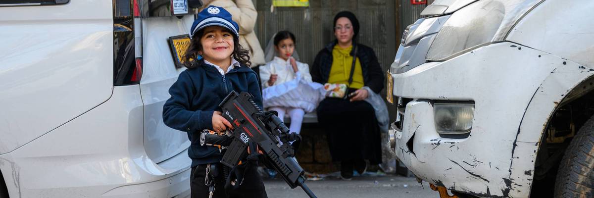 A child carries a toy gun in Jerusalem.
