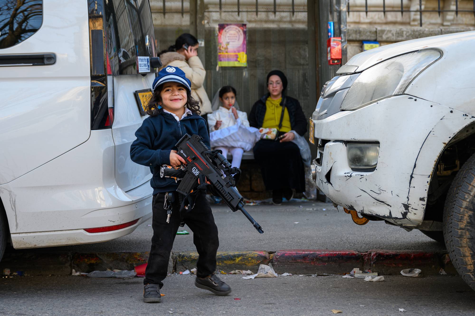 A child carries a toy gun in Jerusalem.