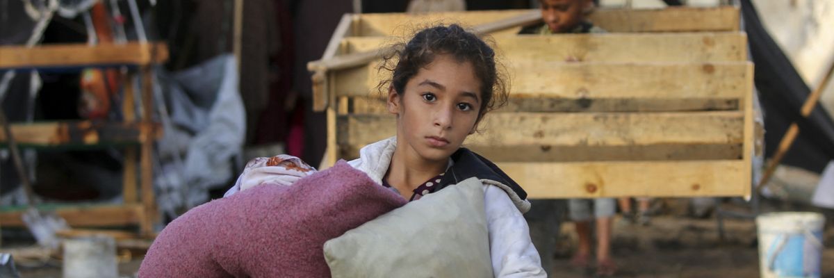 A child carries salvaged items following an Israeli airstrike