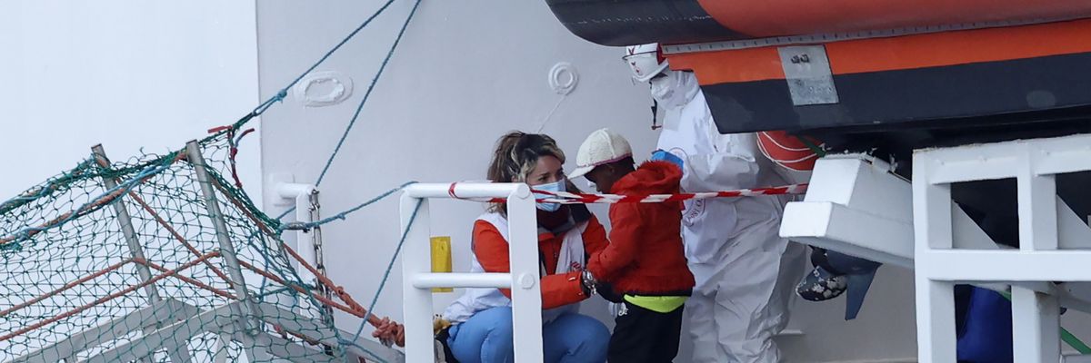 A child disembarks from the Medecins sans Frontieres (Doctors Without Borders) Geo Barents ship