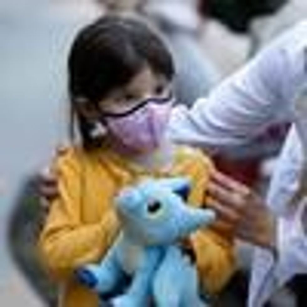 A child gets a Covid-19 vaccine dose