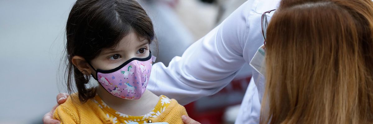 A child gets a Covid-19 vaccine dose