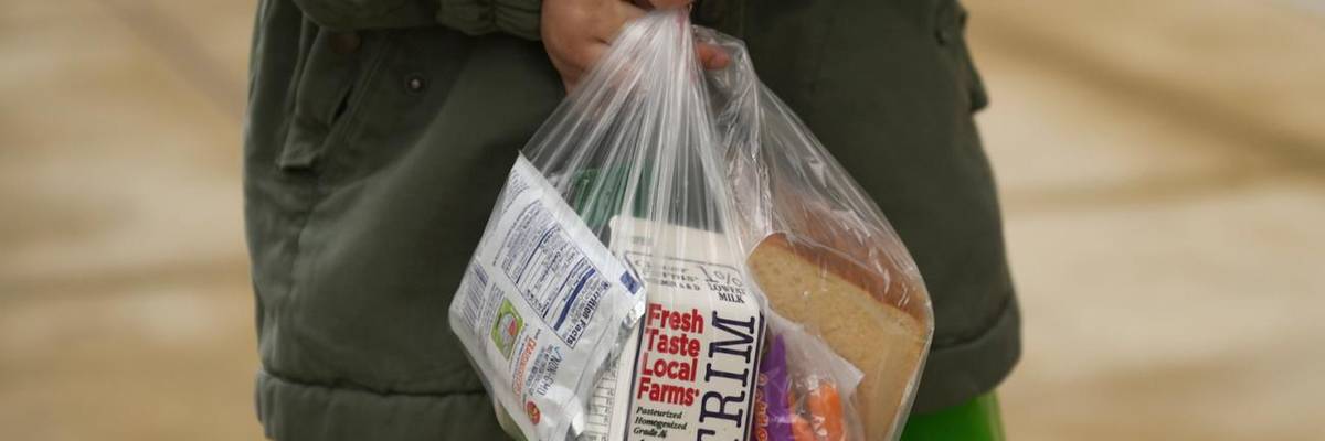A child holds a school lunch.