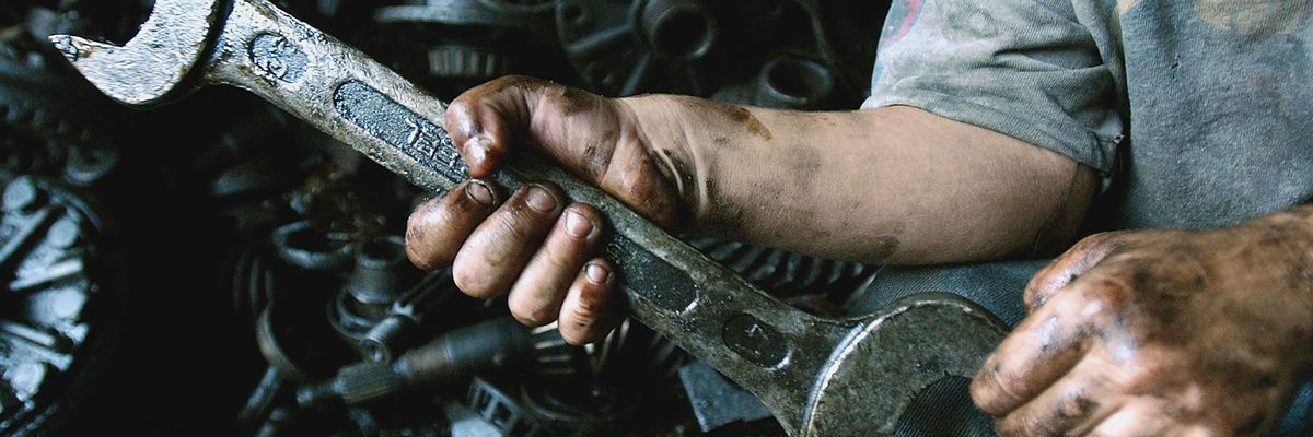 A child holds a wrench