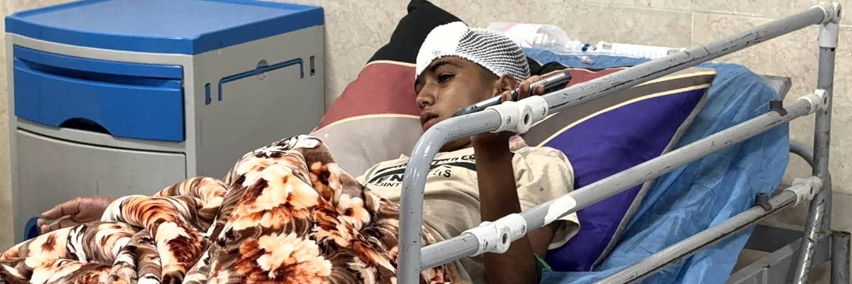 A child in a hospital bed in Iran after being injured in a bombing.