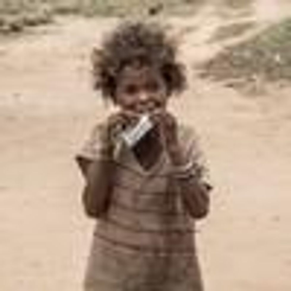 A child in Madagascar eats a nutritional supplement distributed by an NGO.