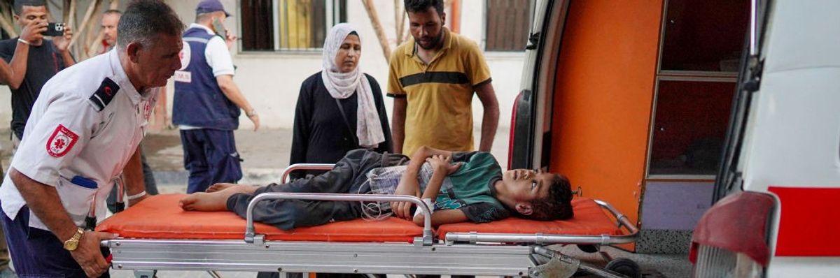 A child is loaded into an ambulance at Al-Nasser Hospital