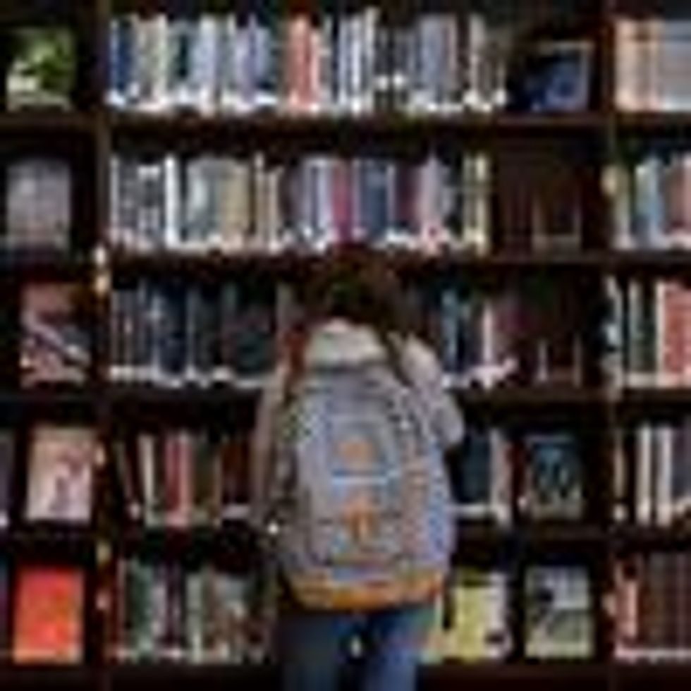 A child looks at books in a school library
