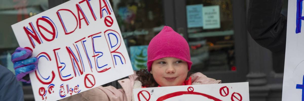 A child protester holds a sign reading, "No Data Center"