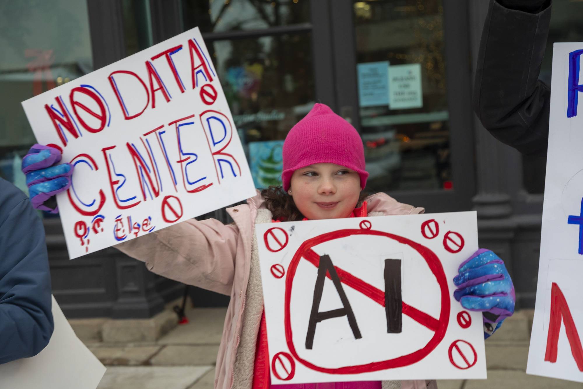 A child protester holds a sign reading, "No Data Center"